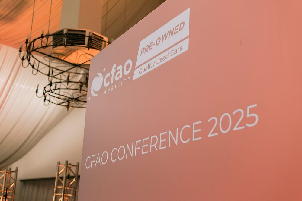CFAO Mobility Pre-Owned Conference 2025 banner displayed at a corporate conference venue with draped white ceiling.