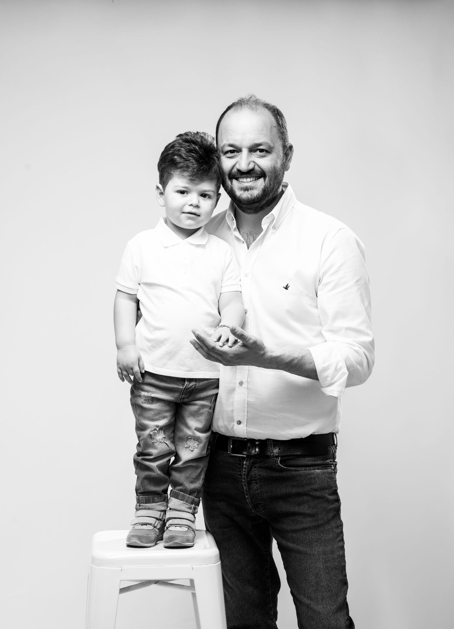 Black and white candid photo series showing special emotional moments between a man and child across four frames.