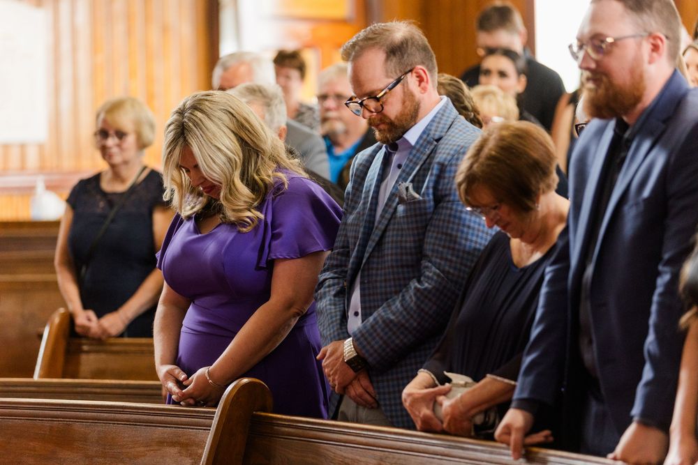 Worshippers bow their heads in prayer during a solemn church service.