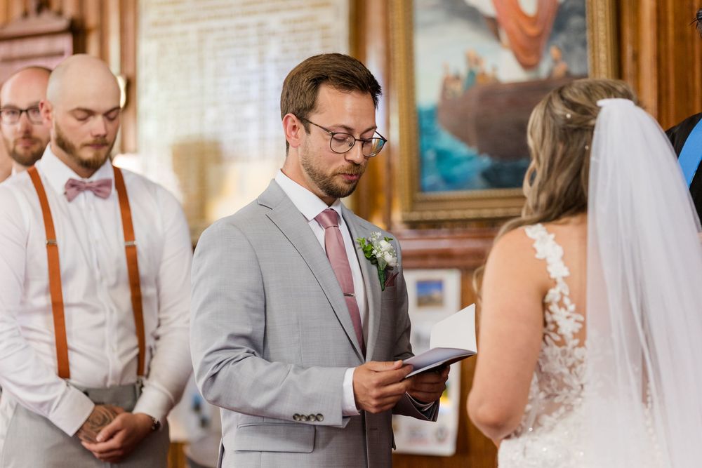 Emotional wedding ceremony moment in a church with traditional decor and stained glass windows.