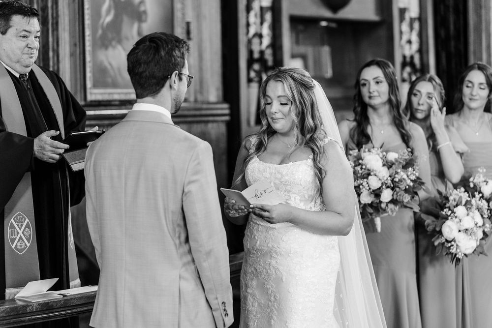 Wedding party getting ready scene captured in black and white photography with natural candid expressions.