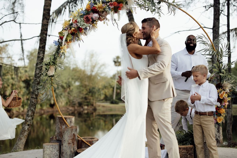 Wedding celebration photos showing tender moments during an outdoor ceremony beneath palm trees.