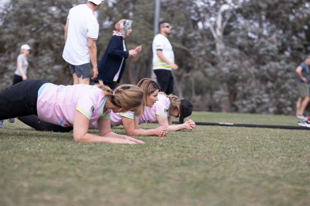 School sports session on the oval, students doing push-ups during an outdoor activity in Canberra.