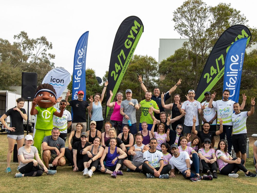 Lifeline Community fun run group photo at the finish area with UAE event banners and participants