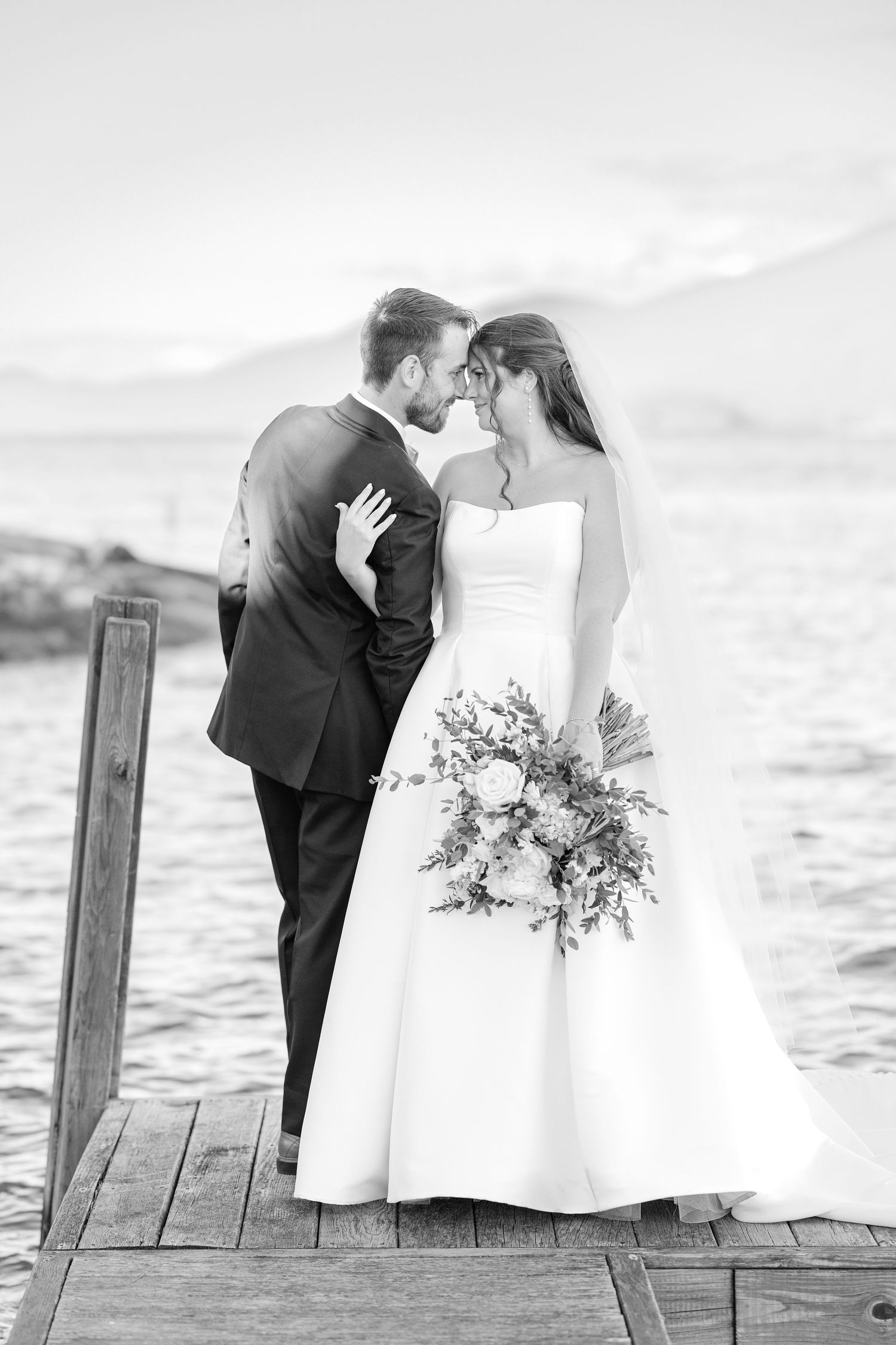 Black and white triptych photo series showing a romantic wedding couple sharing intimate moments on a wooden pier.