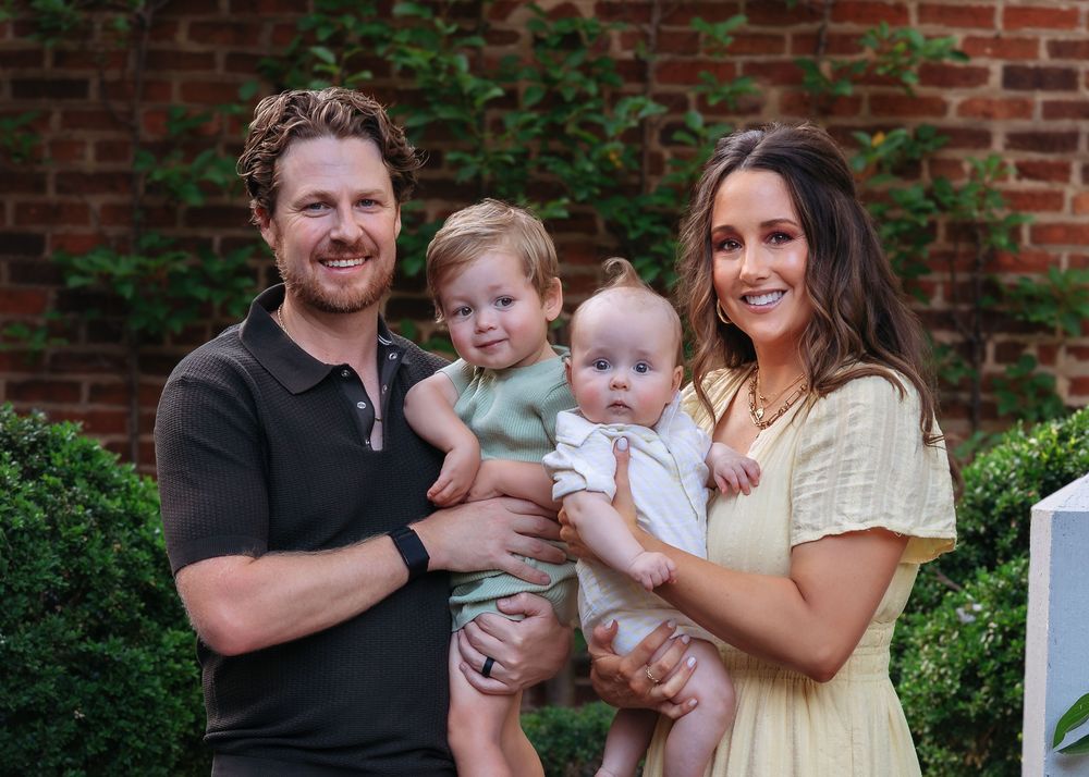 Mom and dad holding their two little boys during Athens, GA family photography session in the garden