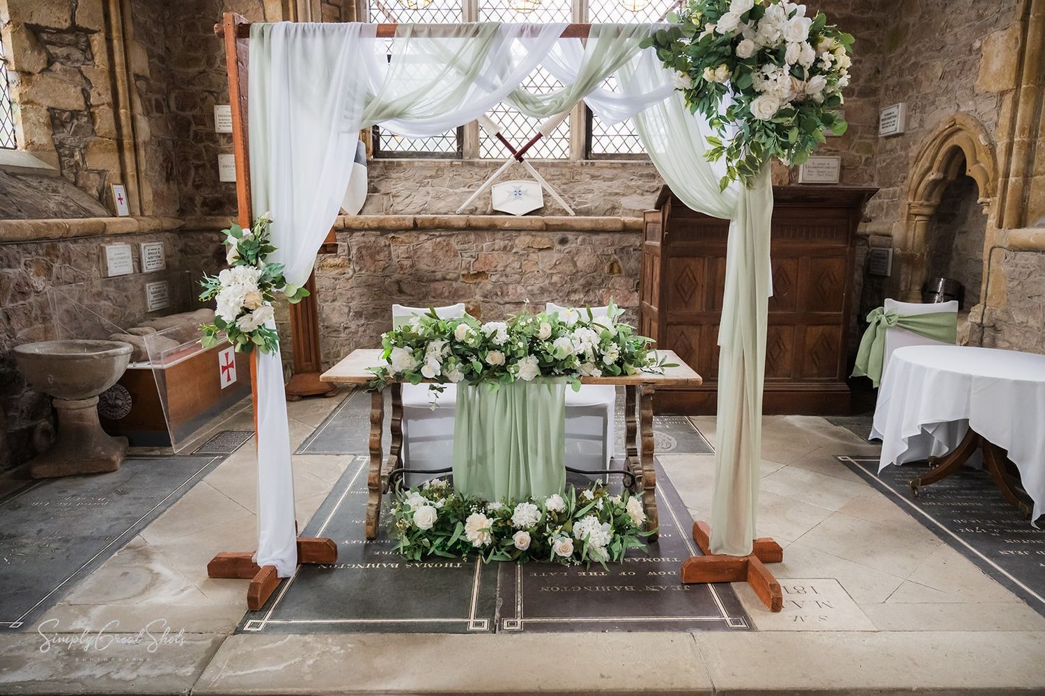 Rothley Court Hotel wedding photographer documenting elegant floral arrangements in medieval chapel