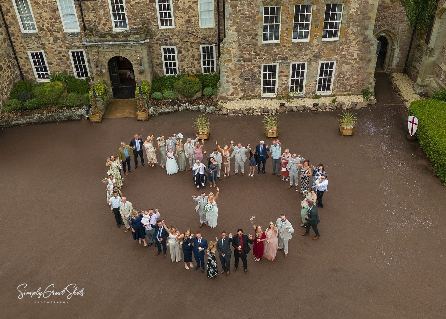 Rothley Court Hotel wedding photographer capturing aerial heart formation in historic courtyard