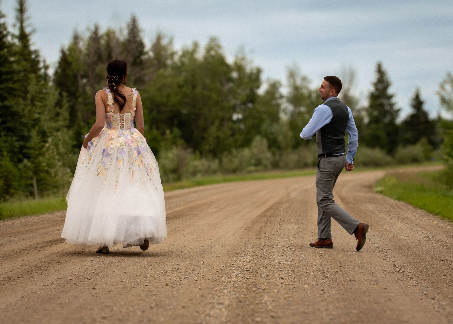 Trendy blurred shot of a wedding party walking around a couple, captured in warm fall tones.