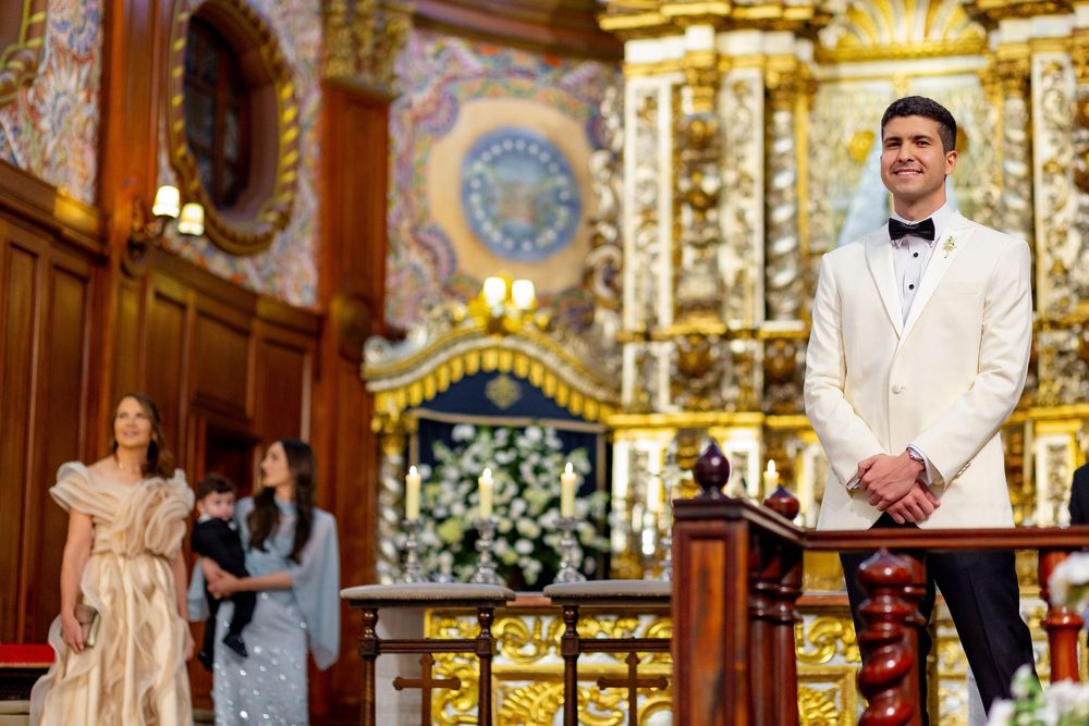 A stunning church wedding ceremony with ornate golden decor and floral arrangements in a traditional Orthodox setting.