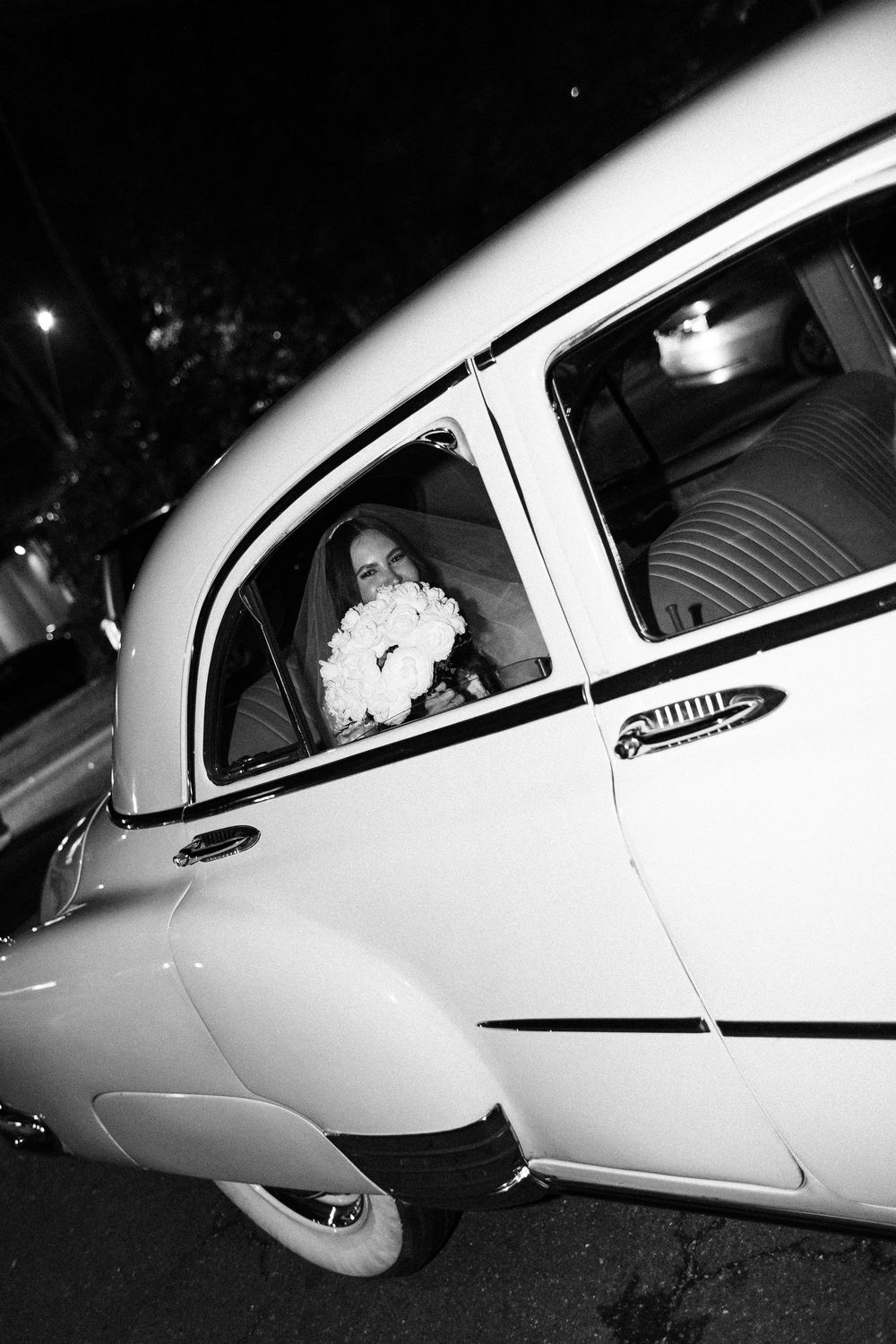 A black and white photographic sequence shows a classic car's profile with successive views of its distinctive side panels.
