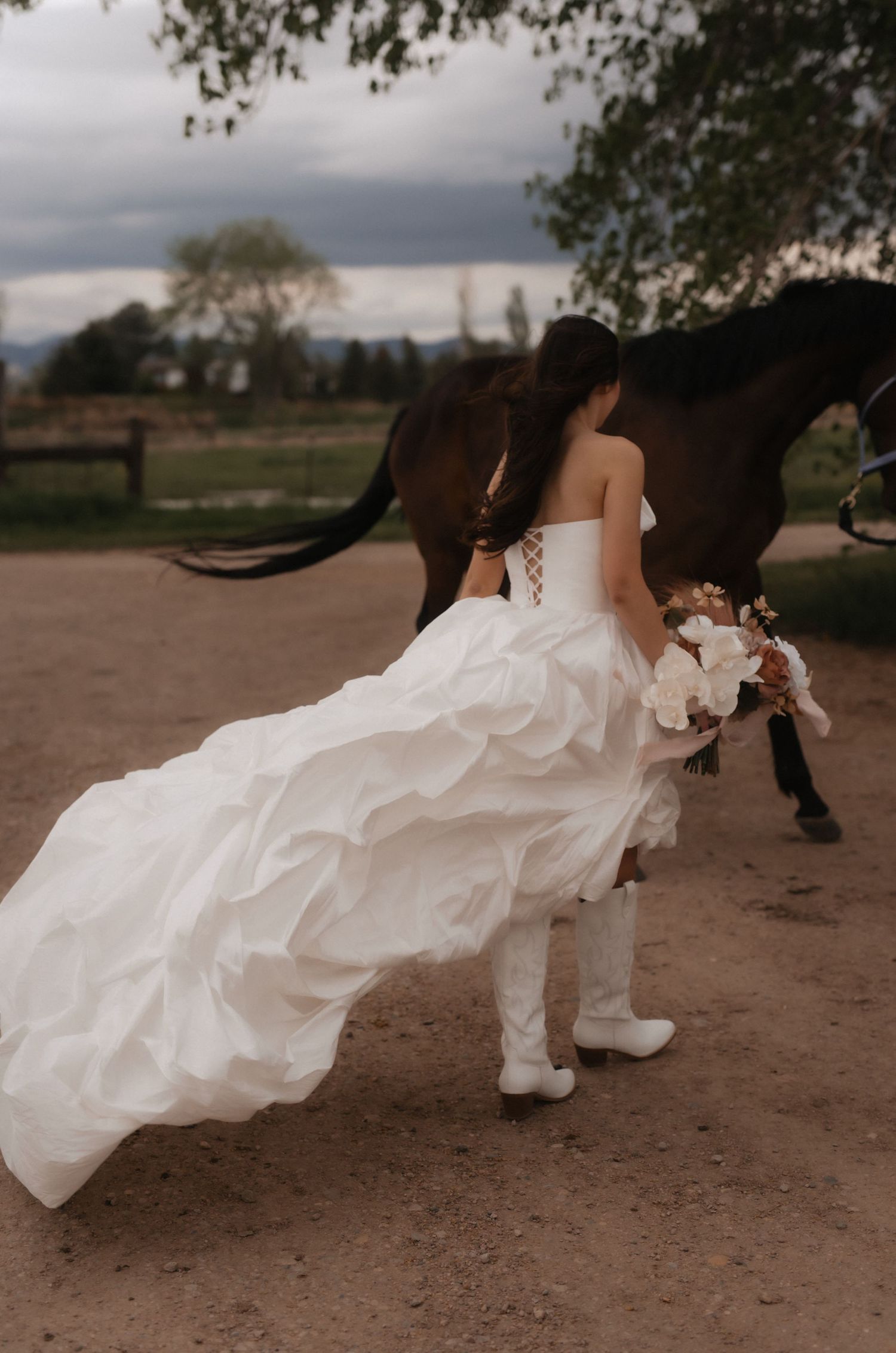 A sequence of photos showing a flowing white wedding dress being blown dramatically by wind on a dirt path.