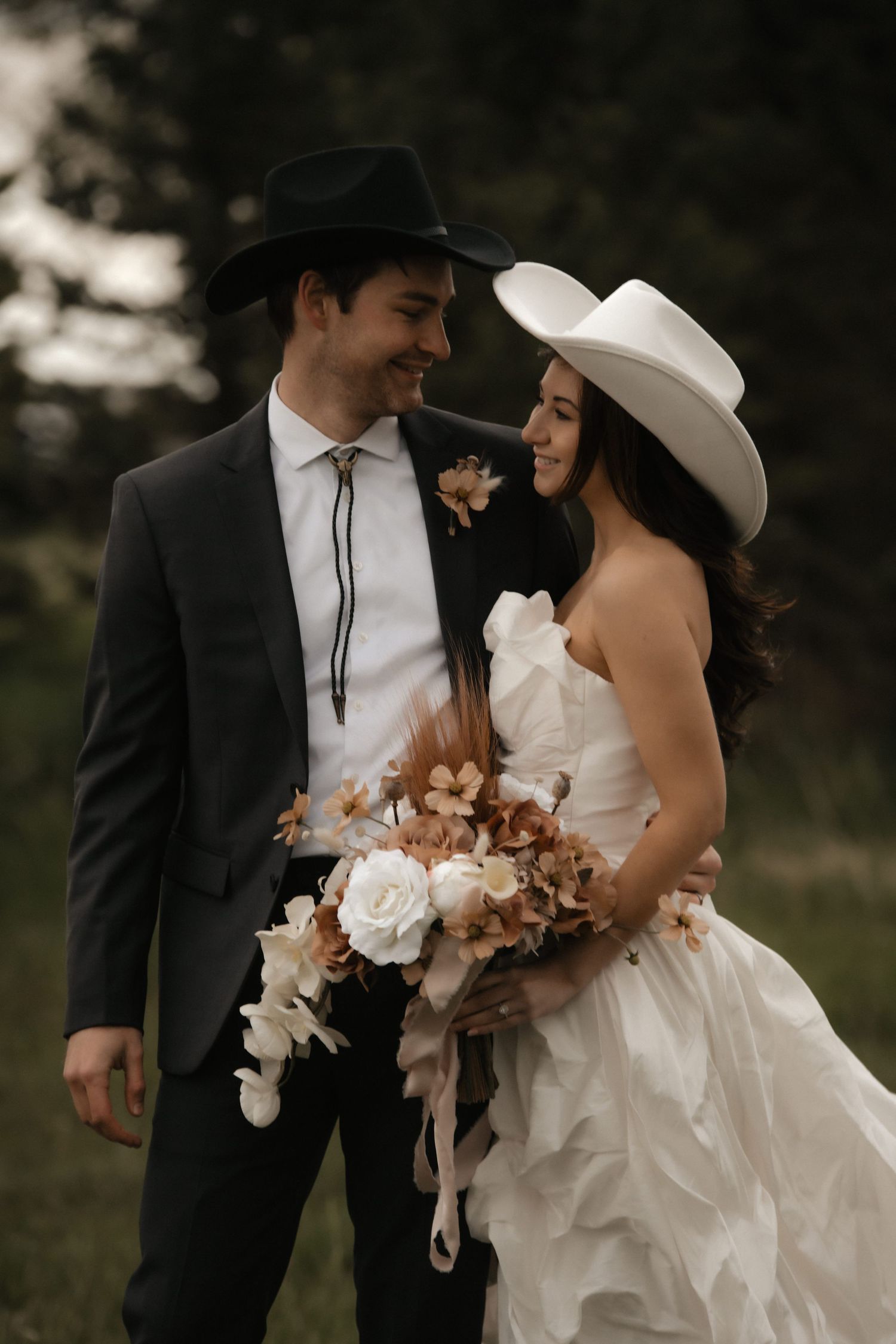 A romantic wedding couple in formal attire share intimate moments in a series of photos with muted earth tones.