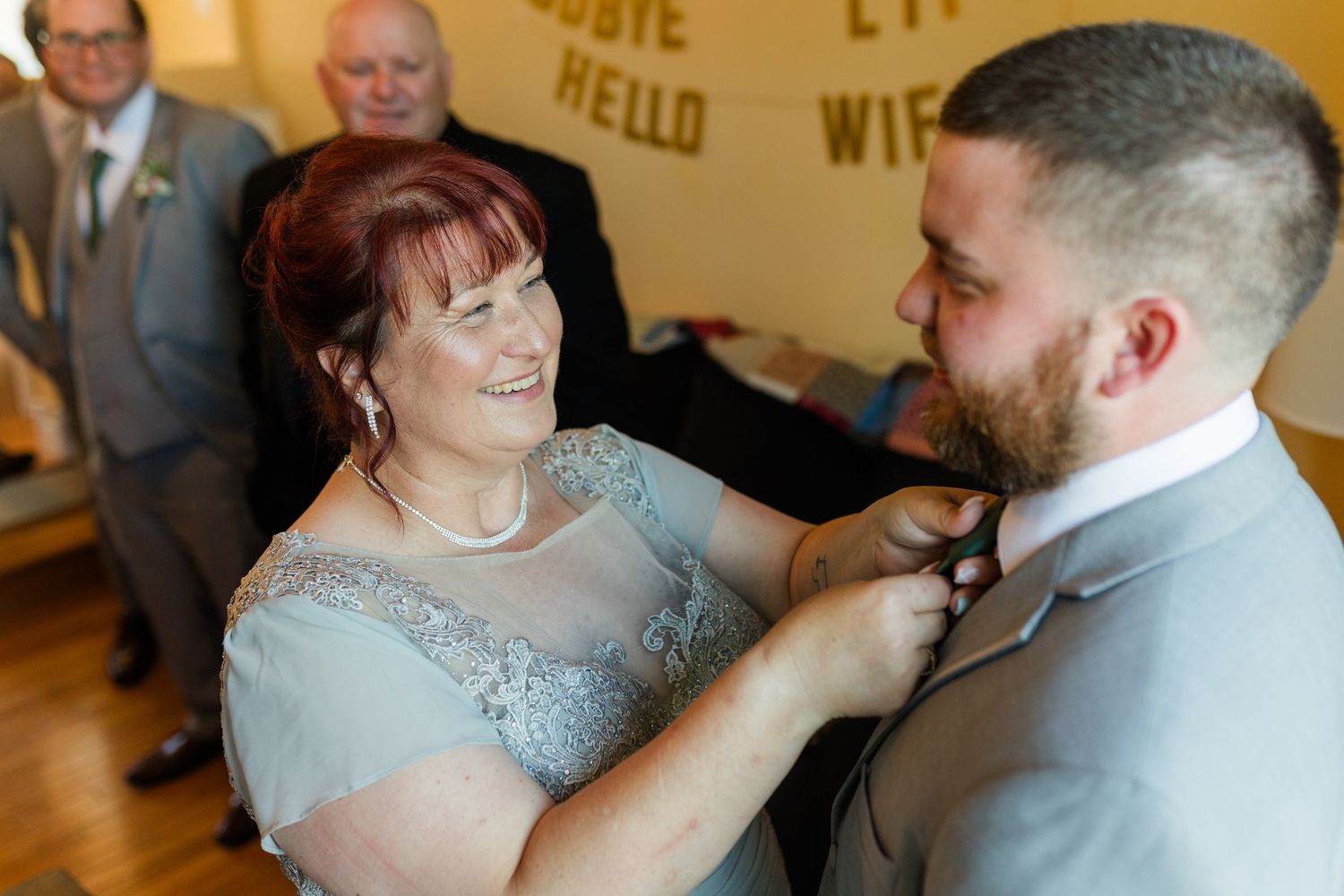 Newlywed couple shares romantic dance moments at their wedding reception in elegant ballroom setting.