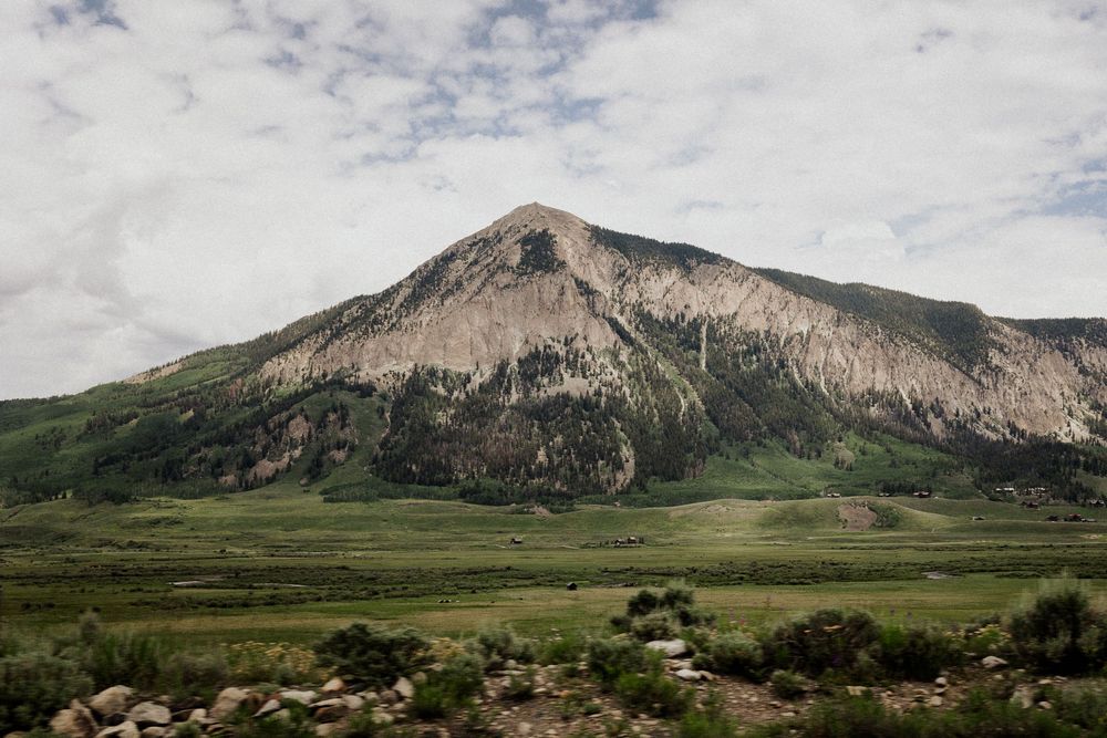 Panoramic view of Crested Butte and green valley in a scenic Colorado landscape during summer.