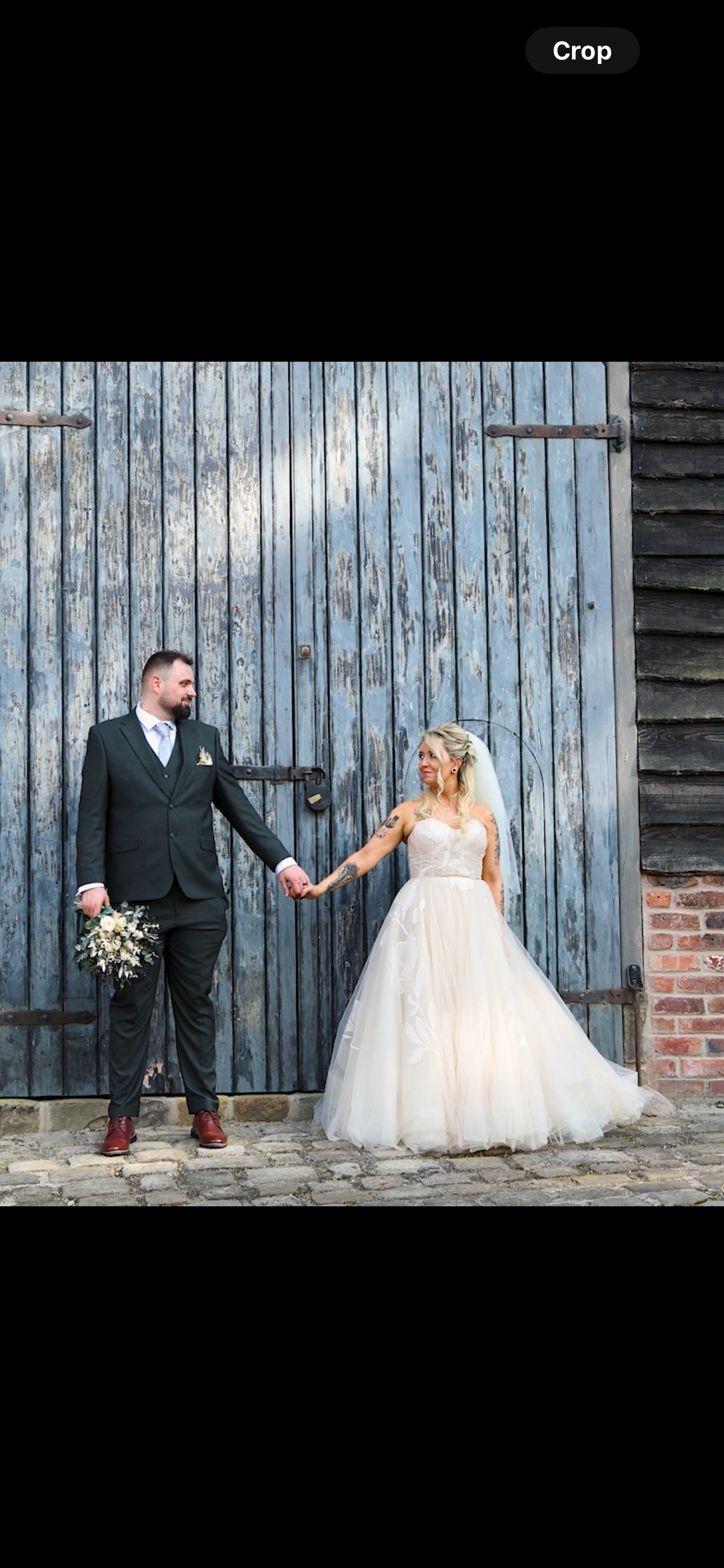 Wedding couple poses playfully against rustic blue wooden barn wall for creative photo sequence.