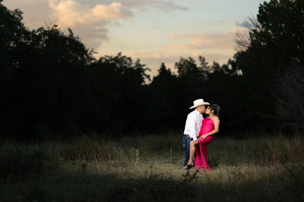 A stunning photo series shows a dancer in pink dress performing gracefully in a sunlit meadow at dusk.