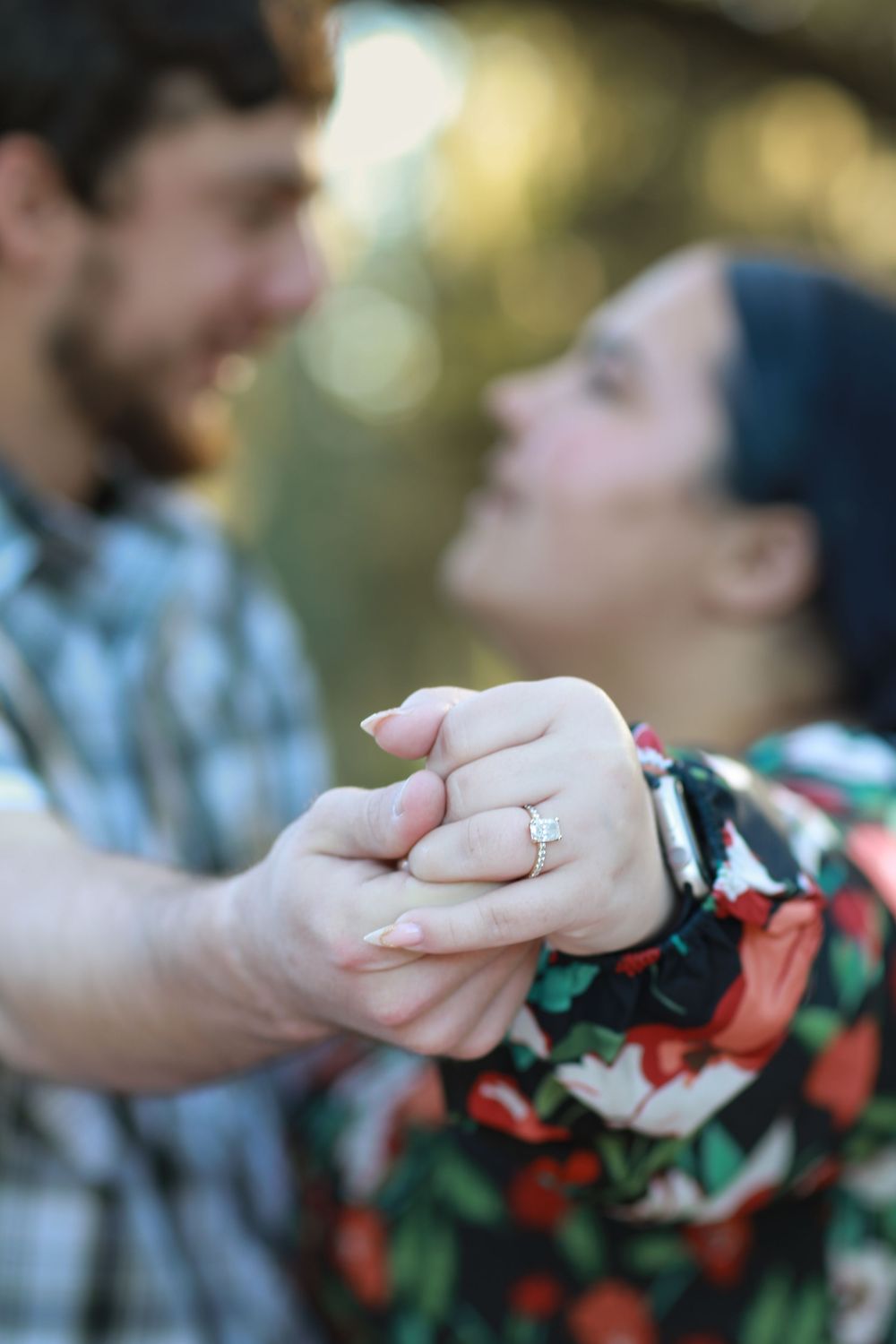 Close-up sequence of two hands holding each other with a blurred background.