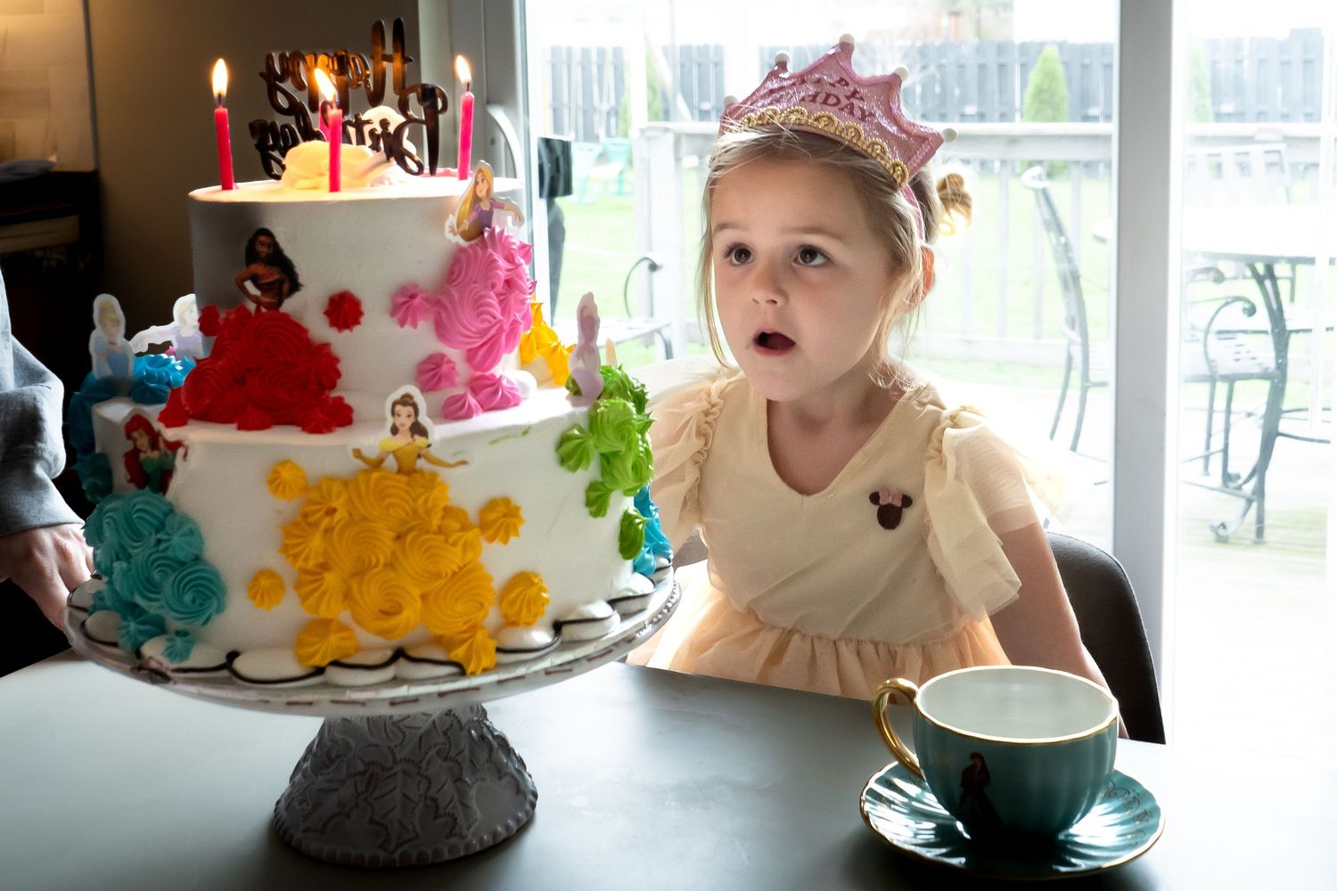 Young child celebrate with colorful cakes and decorations at a festive birthday gathering.