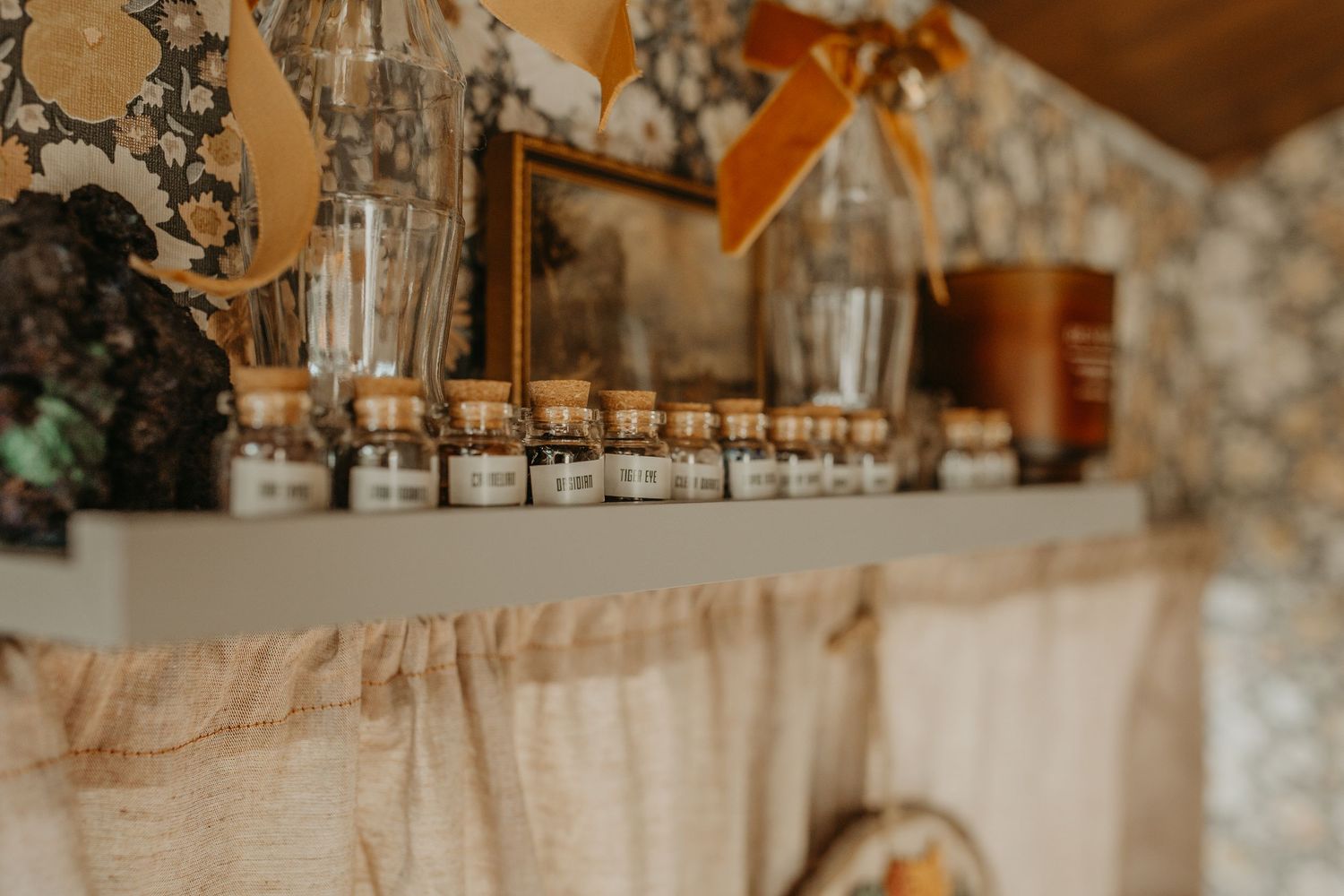 Rustic wedding decorations with white lace tablecloth and twine hanging across an elegant farmhouse setting.