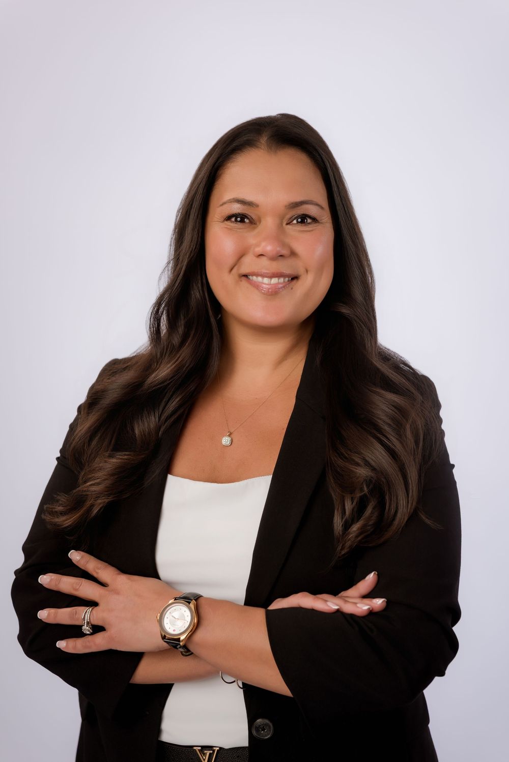 Professional portrait series showing a person in a black blazer and white top posing against a light background.