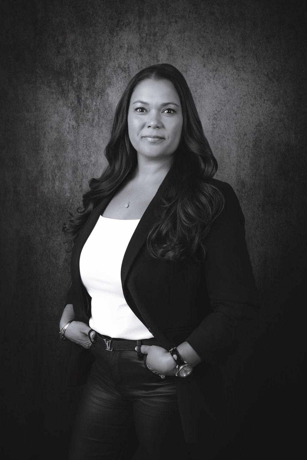 Professional black and white portrait series showing elegant poses against a textured background.