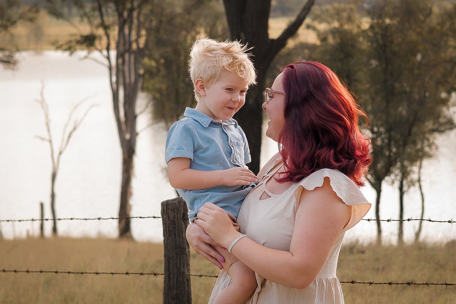 afternoon family photo session at gordonbrook dam in Kingaroy with mother and son lovingly looking at each other