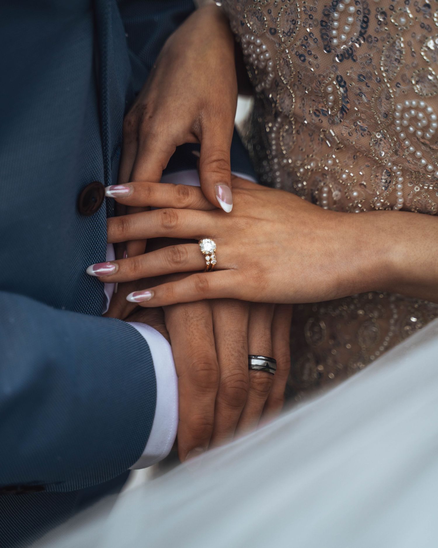 Wedding rings on couple's hands. Calgary wedding photography.