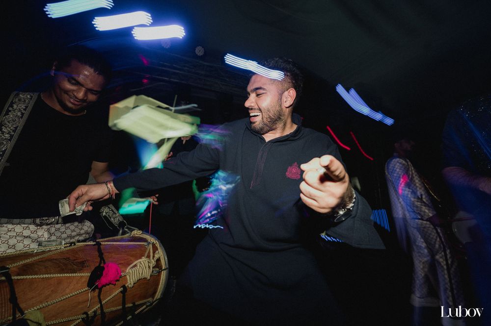 Musicians performing with drums under blue stage lights at a festive event.