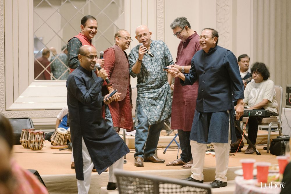 A group mingles and socializes during an indoor celebration.