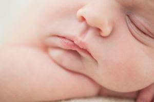 Close-up detail of a newborn's lips and cheeks in a soft, dreamy shot by Phoebe Lee Photo in Toronto