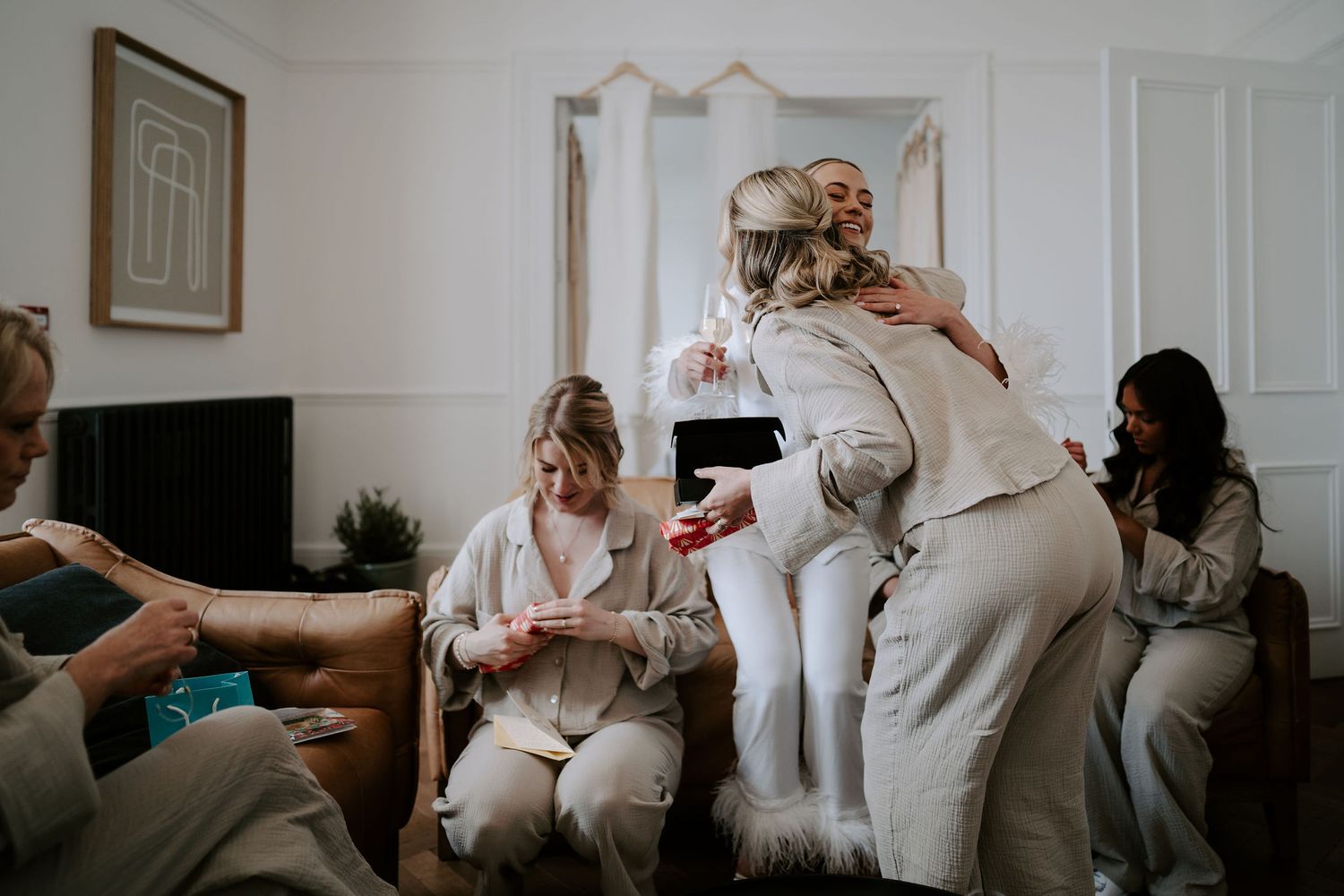 Tunnels Beach Wedding Venue in North Devon, Bride giving gifts to bridesmaids and mum