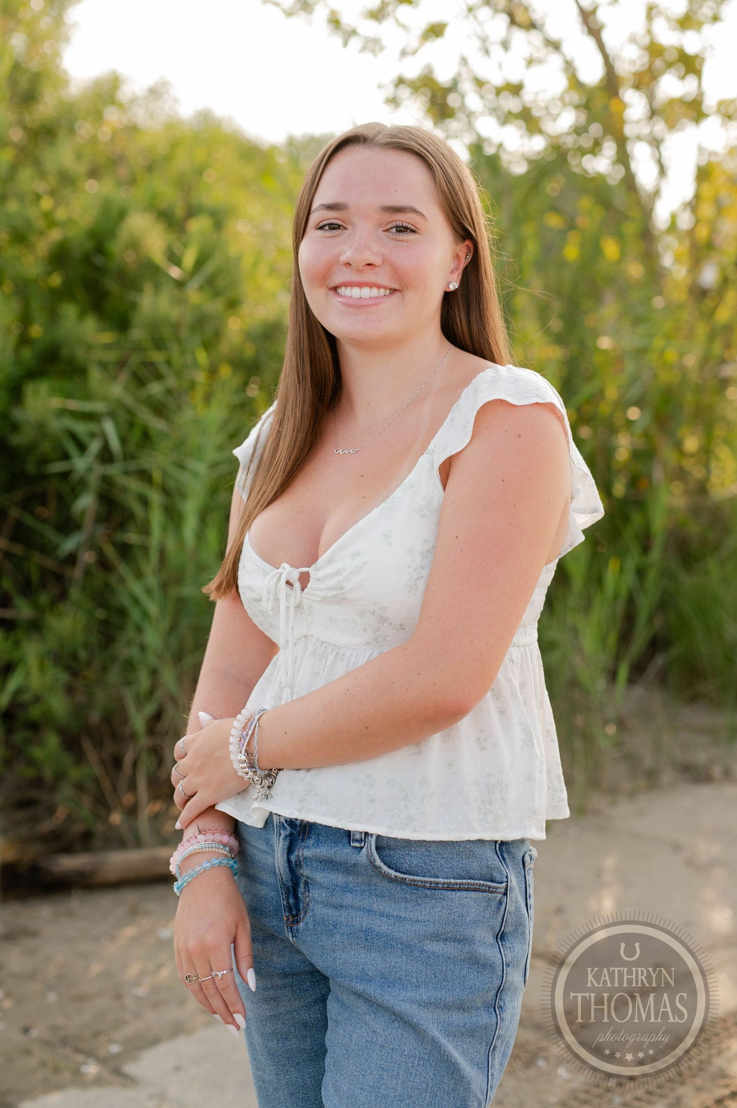 A summer portrait featuring a white top and casual denim in natural lighting.