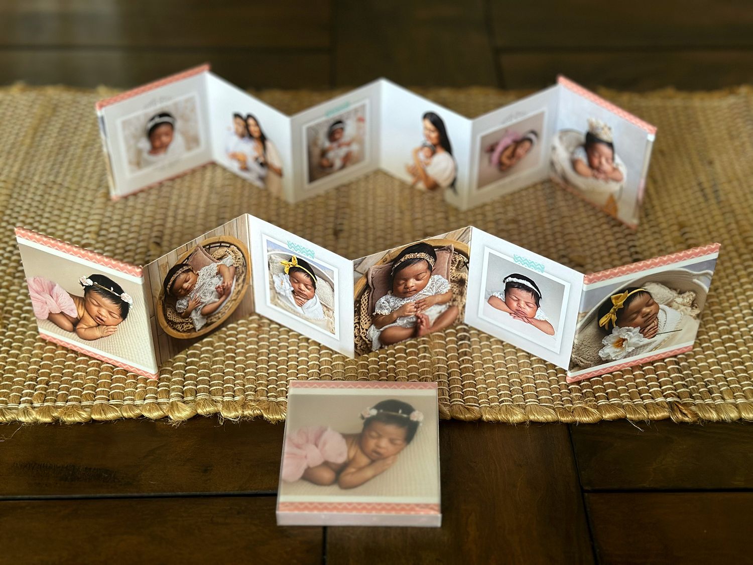 Miniature accordion-style photo albums displayed on burlap fabric with family portraits inside.