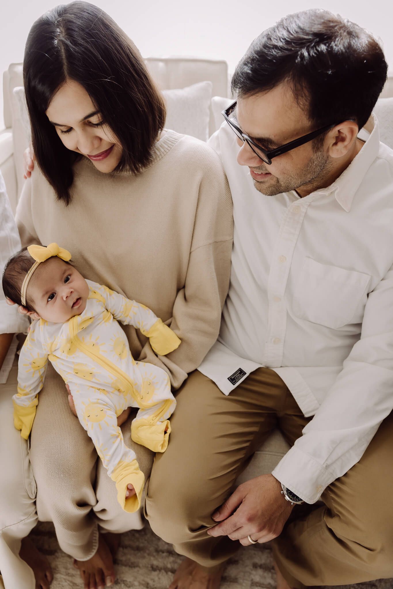 Newborn baby with parents in cozy Union City home during lifestyle photo session
