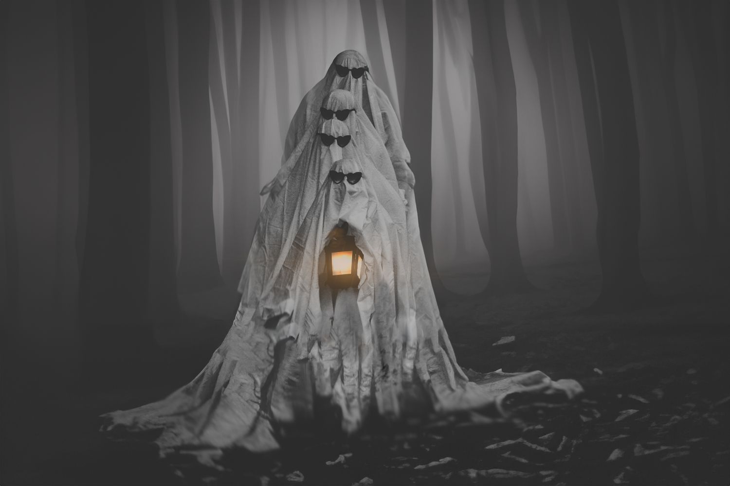 Spooky glowing house made of white fabric in misty forest.