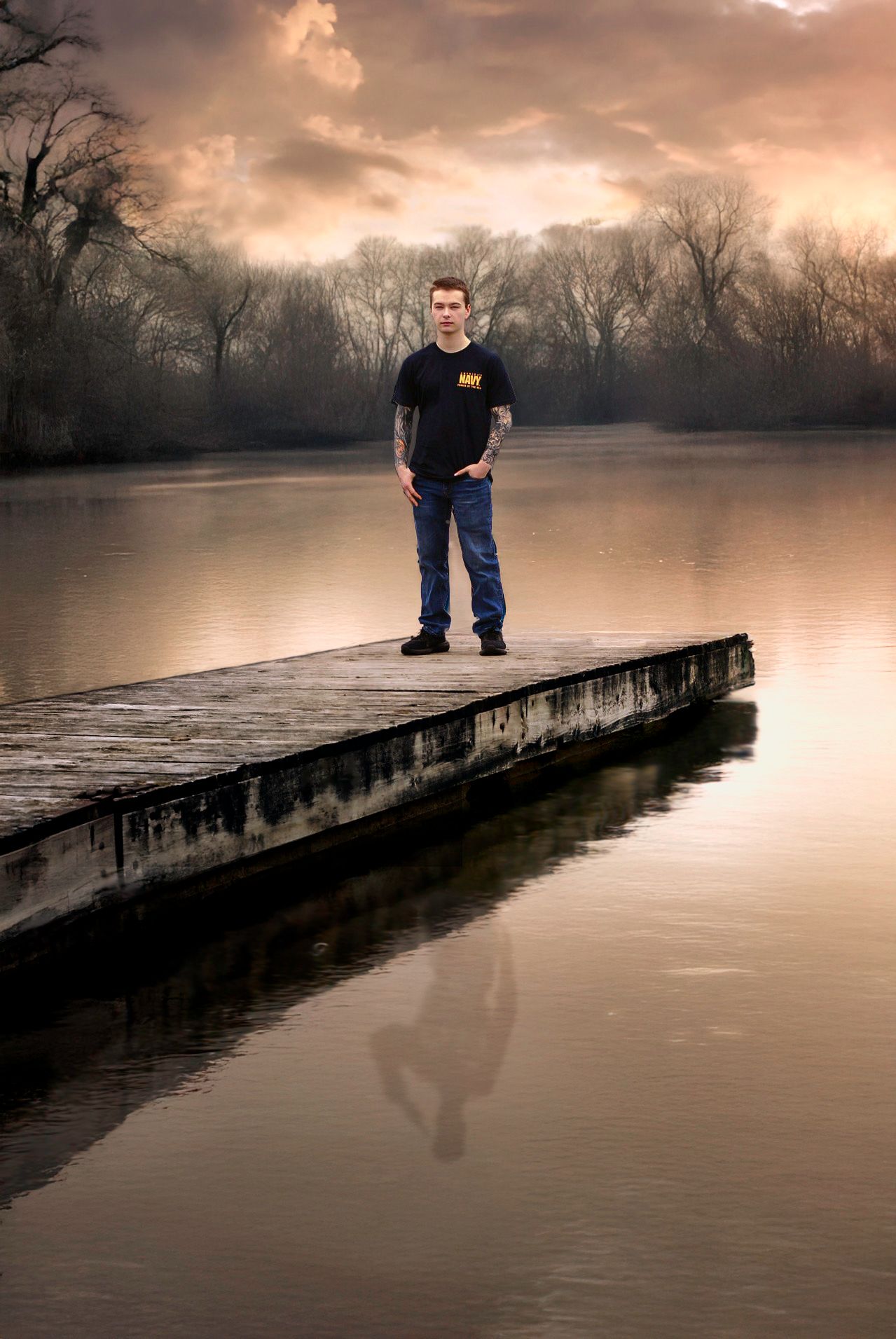 Moody portraits on a wood  pier over still water at sunset.