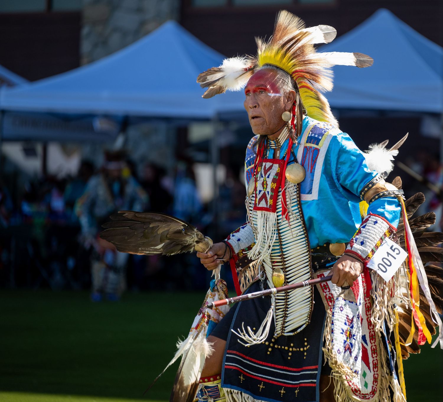 A Native American dancer in traditional regalia performs at a cultural celebration.