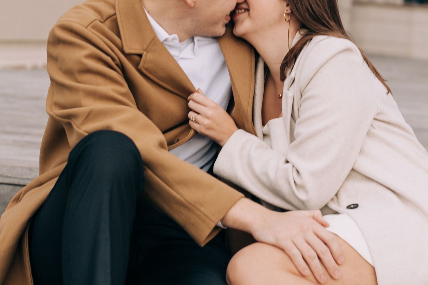 Intimate moment of a couple during an engagement session on steps near the river in Milwaukee