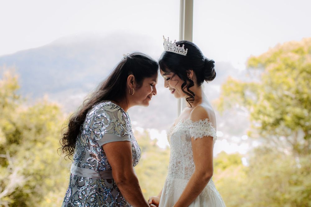 An intimate outdoor wedding moment captured against a mountain backdrop.