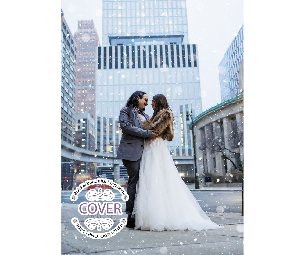 A couple in wedding attire embrace in front of skyscrapers on a city street in winter.
