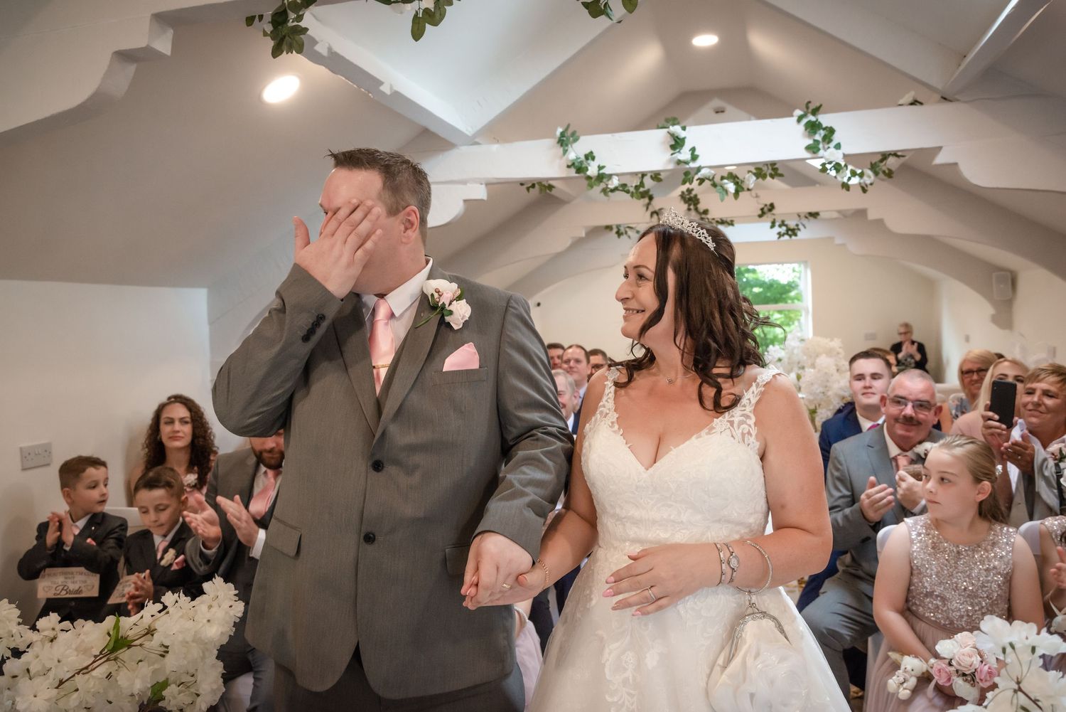emotional groom holding hands with his bride at The Joshua Bradley during their wedding ceremony by wedding photographer Michael Pardoe