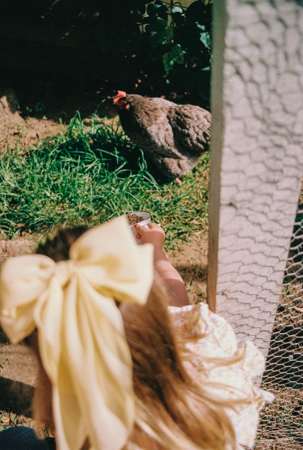 An elegant cream-colored gown with delicate details spreads out against a stone pathway.