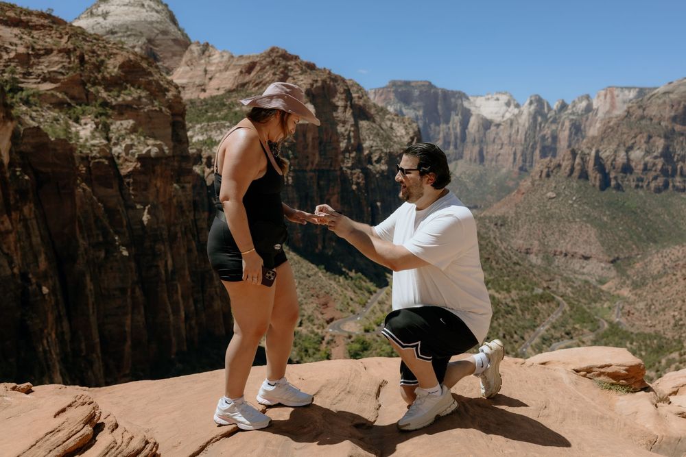 A series of photos showing a surprise proposal moment at a scenic mountain overlook in Zion National Park.