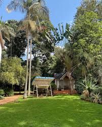 luxury garden wedding venue in Nairobi, captured by Nairobi Wedding Photographer, Bonnie Gichuru, showcasing lush greenery and flower arches