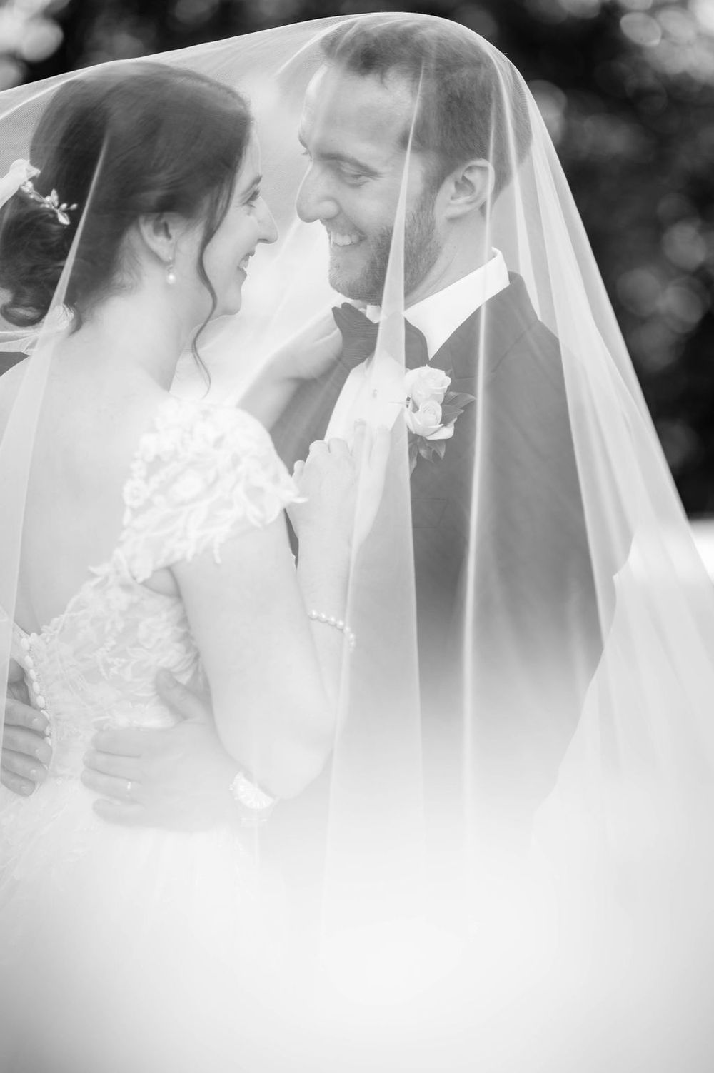 Romantic wedding portrait through a delicate white veil.