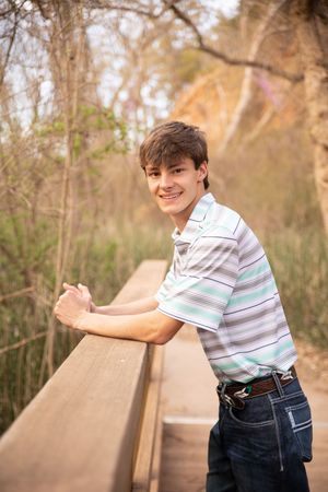 A series of candid outdoor portraits showing someone leaning on a wooden railing in a natural wooded setting at sunset.