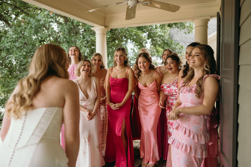 A group of bridesmaids sharing an emotional moment during the first look with the bride at Summerour Studio in Atlanta, Georgia
