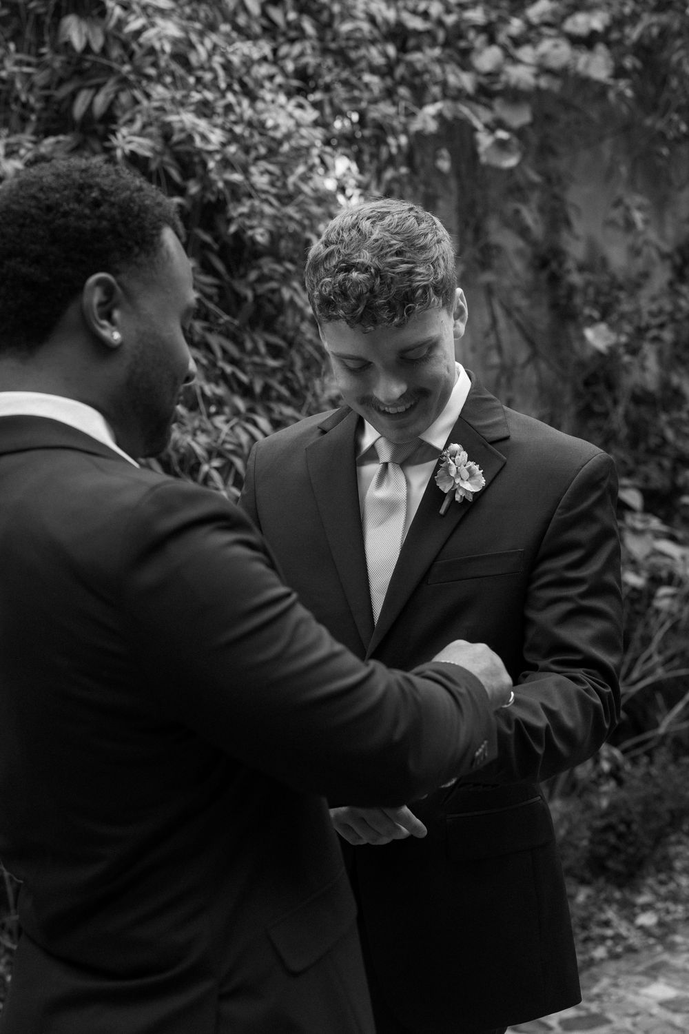 The groom is having his cuff links adjusted by a groomsman before the wedding in Atlanta at Summerour Studio
