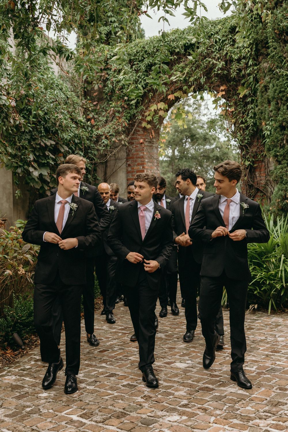 Groomsmen walking together outdoors for portraits at Summerour Studio in Atlanta, Georgia